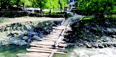 lolab village residents risk lives crossing makeshift wooden bridge