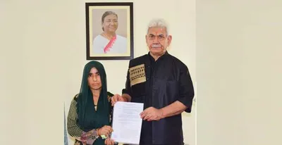 lg sinha hands over appointment letter to wife of slain bus driver