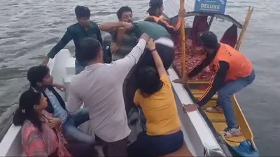 tourists rescued after wind storm in dal lake
