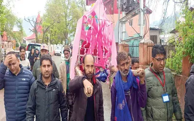 elderly woman carried in palanquin for voting in bhaderwah