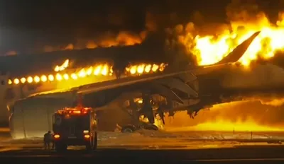 japan airlines plane catches fire at tokyo airport  all 379 passengers  crew escape