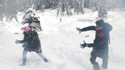 tourists enjoy as snow blankets doodhpathri resort in central kashmir