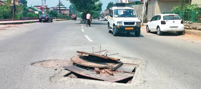 uncovered  damaged manholes pose threat to commuters in srinagar